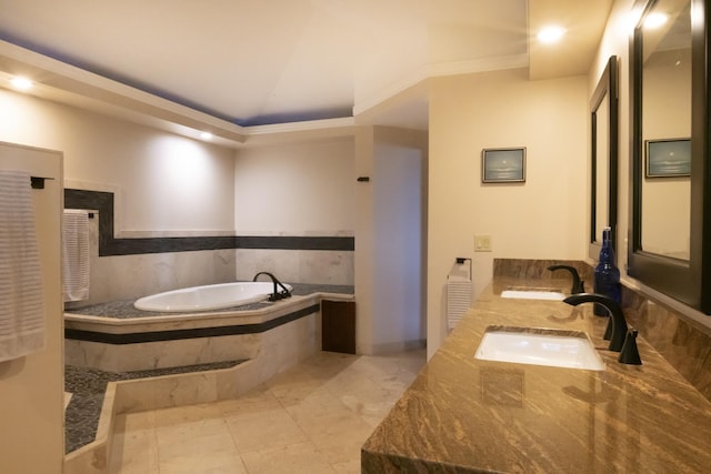 bathroom featuring vanity, lofted ceiling, tiled bath, and ornamental molding