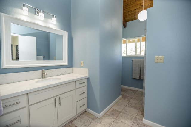 bathroom with vanity, wood ceiling, and vaulted ceiling