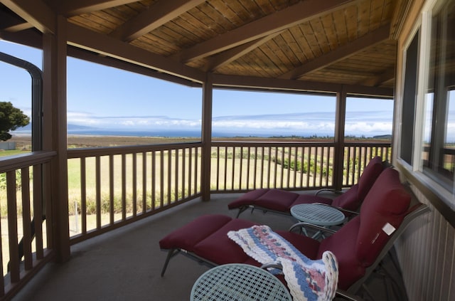 sunroom featuring beam ceiling and wooden ceiling