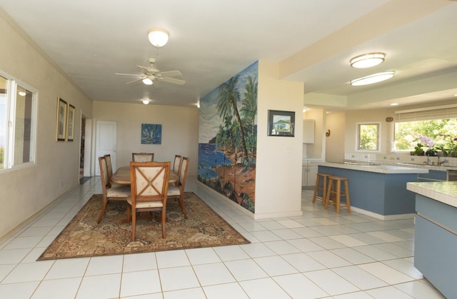 tiled dining space featuring ceiling fan