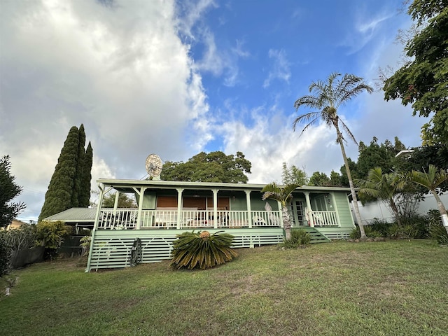 view of front of home featuring a front yard and a porch