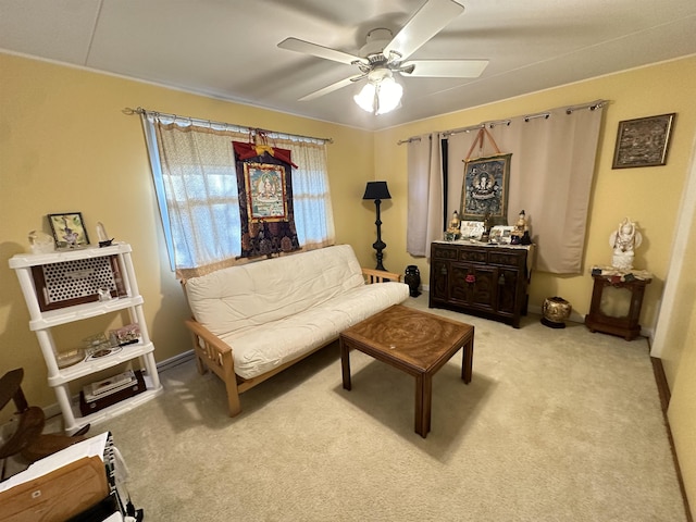 living area with light colored carpet and ceiling fan