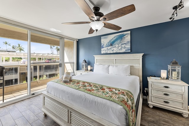 bedroom with ceiling fan, track lighting, access to exterior, and floor to ceiling windows