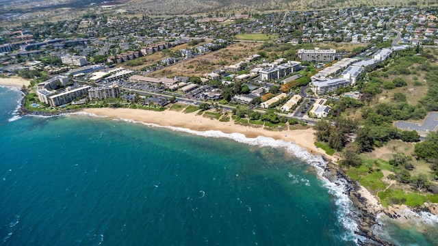 birds eye view of property featuring a water view and a beach view