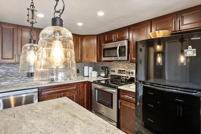 kitchen with stainless steel appliances, backsplash, light stone countertops, and decorative light fixtures