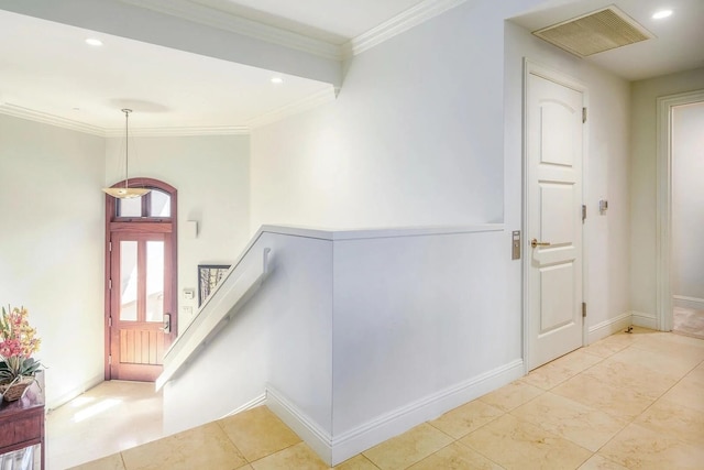 interior space with light tile patterned floors and crown molding