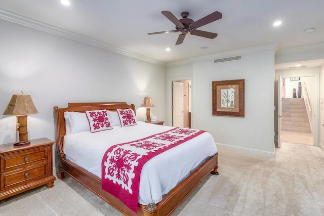 carpeted bedroom featuring crown molding, ceiling fan, and ensuite bath