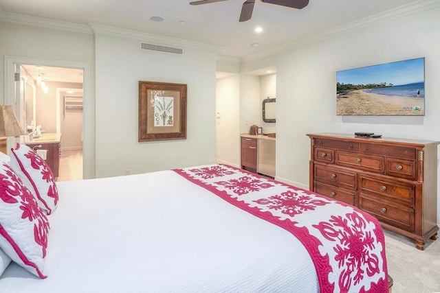 carpeted bedroom with connected bathroom, ornamental molding, and ceiling fan