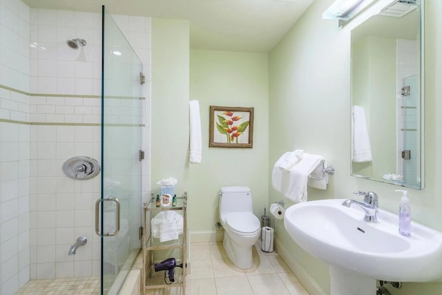 bathroom featuring an enclosed shower, sink, tile patterned flooring, and toilet