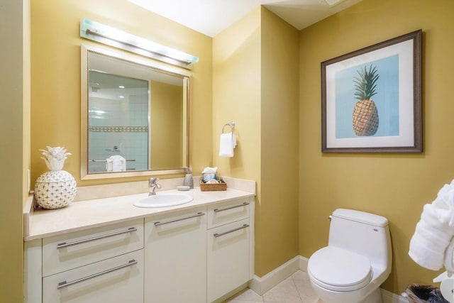 bathroom with tile patterned flooring, vanity, and toilet