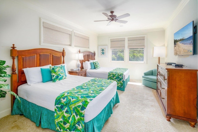 carpeted bedroom featuring crown molding and ceiling fan