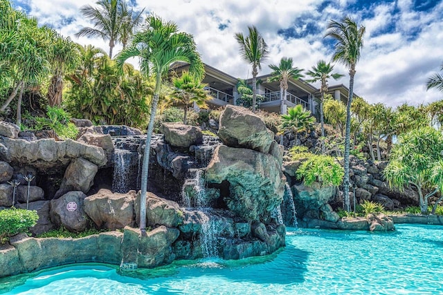 view of swimming pool featuring pool water feature