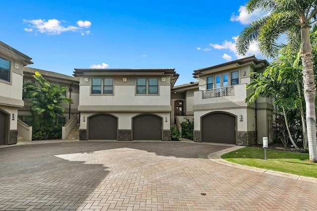 view of front of house with a garage and a balcony