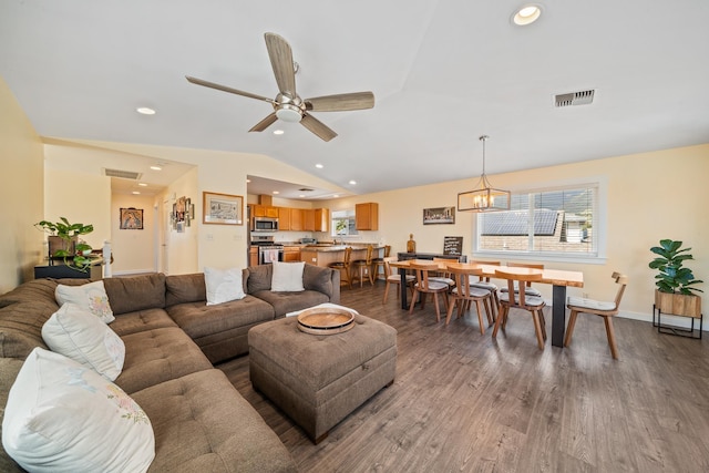 living area featuring visible vents, recessed lighting, lofted ceiling, and wood finished floors