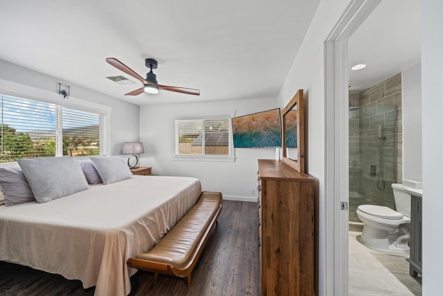 bedroom with visible vents, connected bathroom, baseboards, wood finished floors, and a ceiling fan