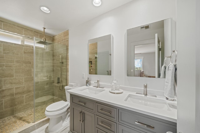 bathroom with a sink, visible vents, and a shower stall