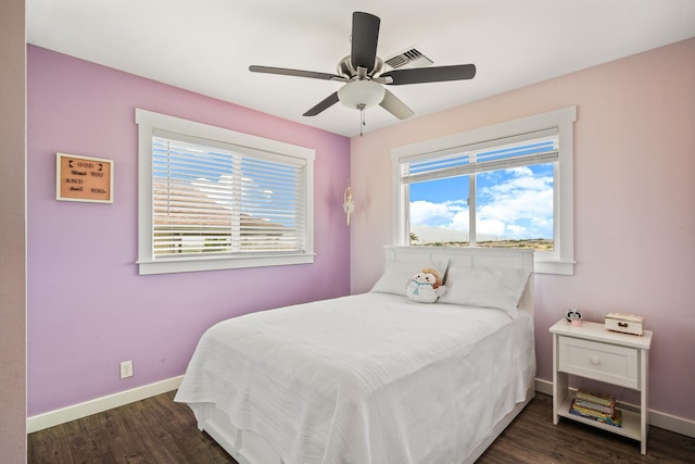 bedroom featuring visible vents, baseboards, a ceiling fan, and dark wood-style flooring