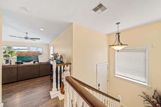 hallway featuring wood finished floors, recessed lighting, an upstairs landing, and visible vents