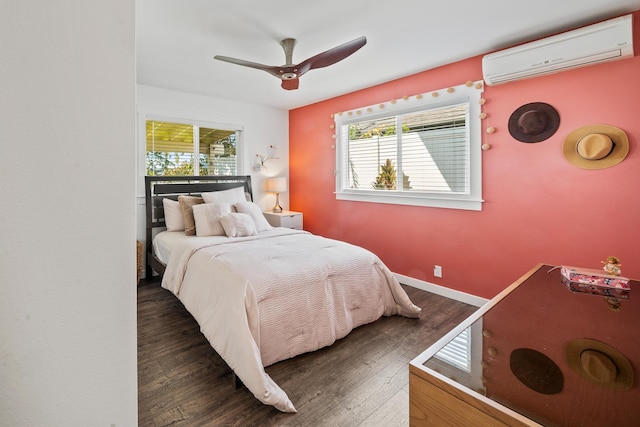 bedroom with a ceiling fan, wood finished floors, baseboards, and a wall mounted AC