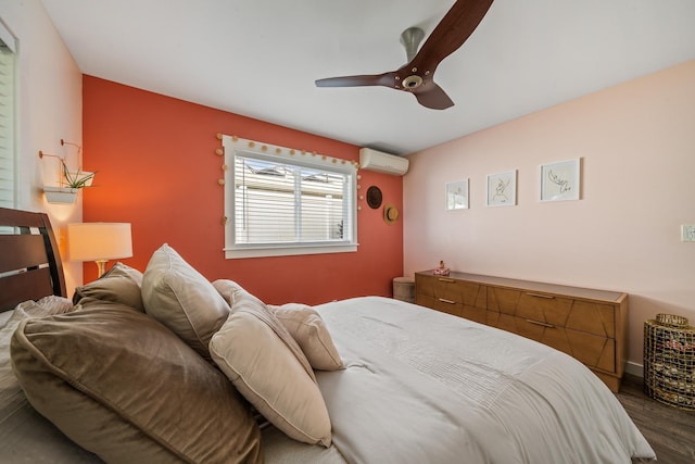 bedroom featuring dark wood-style floors, an AC wall unit, and ceiling fan