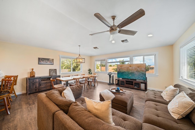 living area featuring dark wood-style floors, visible vents, and baseboards