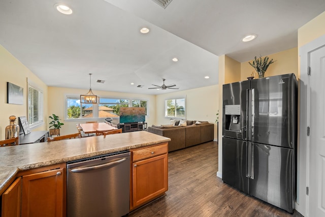 kitchen with dark wood-style floors, recessed lighting, brown cabinetry, and appliances with stainless steel finishes