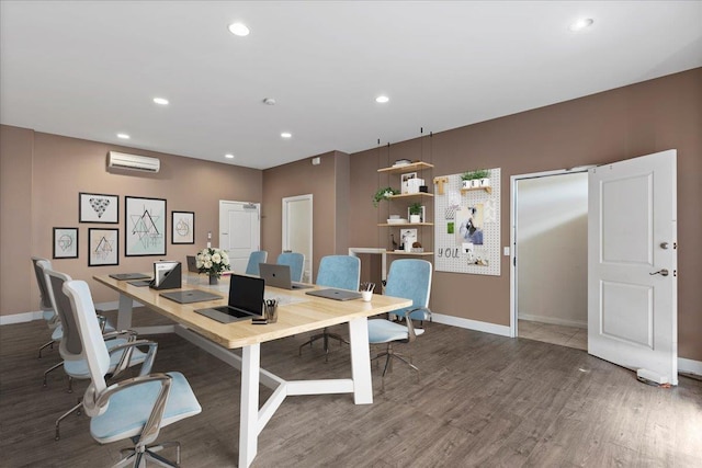 office area with a wall mounted air conditioner and dark hardwood / wood-style flooring