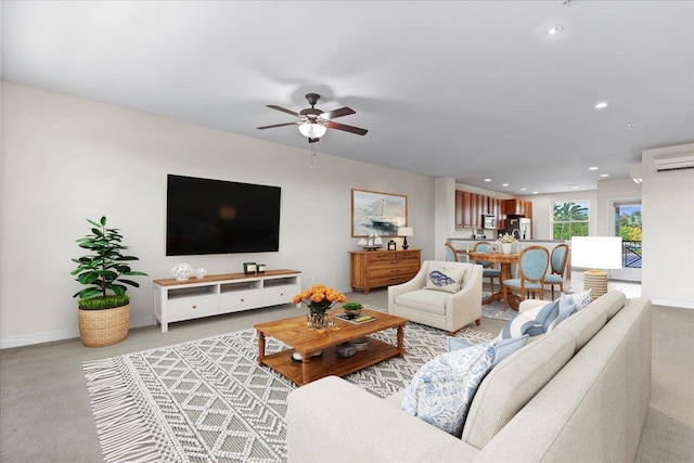 living room featuring ceiling fan, a wall mounted AC, and light colored carpet