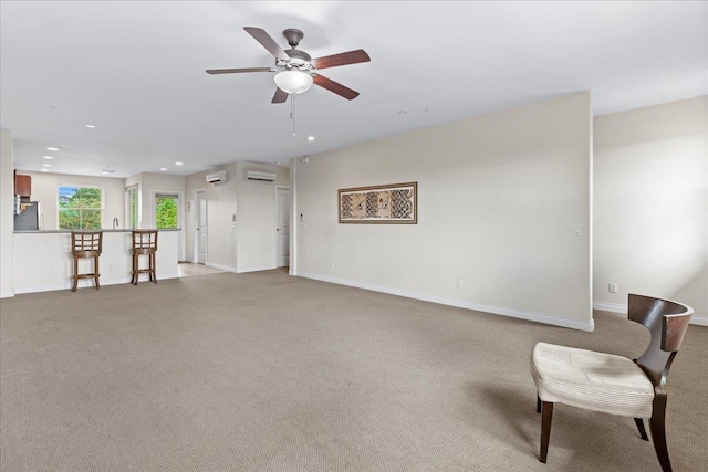 living room featuring light carpet, a wall unit AC, and ceiling fan