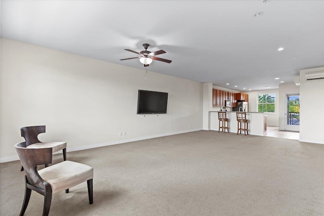 sitting room featuring ceiling fan and light colored carpet