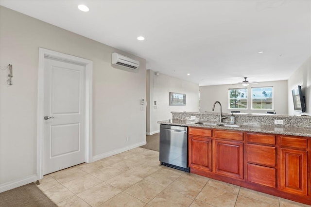 kitchen with stainless steel dishwasher, sink, light stone counters, light tile patterned flooring, and an AC wall unit