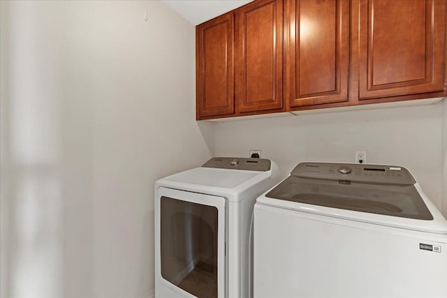 laundry area featuring cabinets and washer and clothes dryer