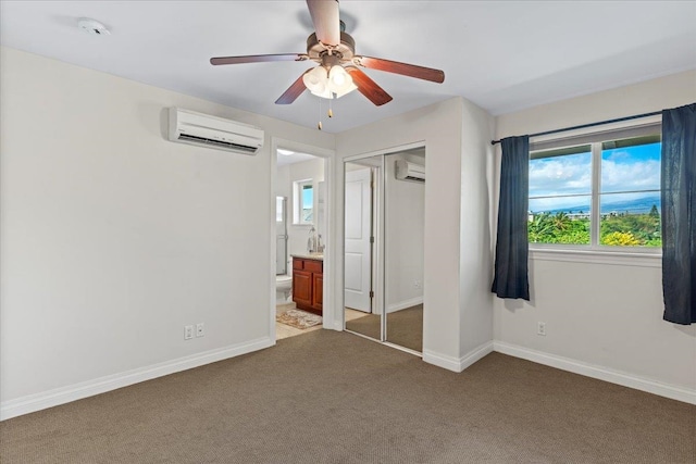 unfurnished bedroom featuring a closet, ceiling fan, carpet, and an AC wall unit