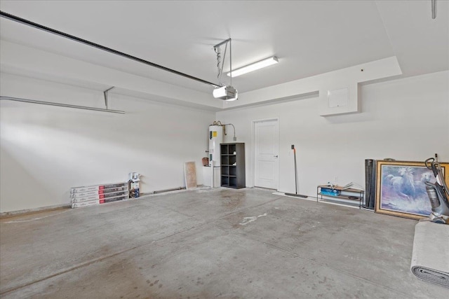 garage featuring electric water heater and a garage door opener