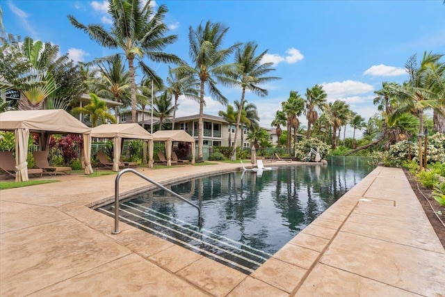 view of swimming pool featuring a water view and a gazebo