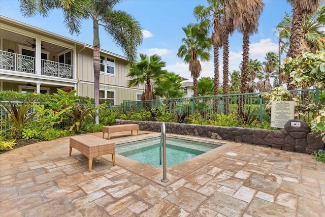 view of swimming pool featuring a patio area and a hot tub