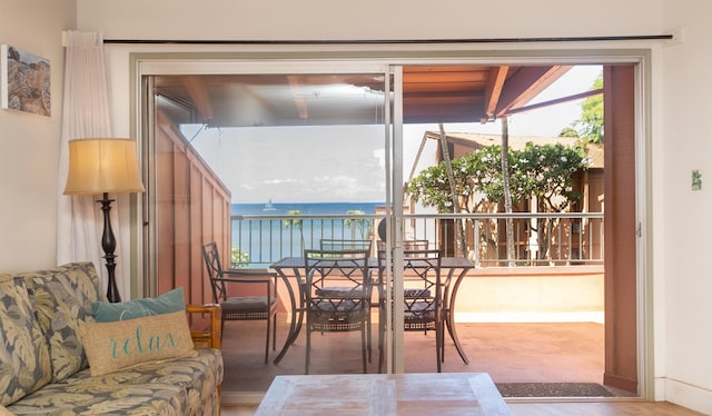 interior space with wood-type flooring and a water view