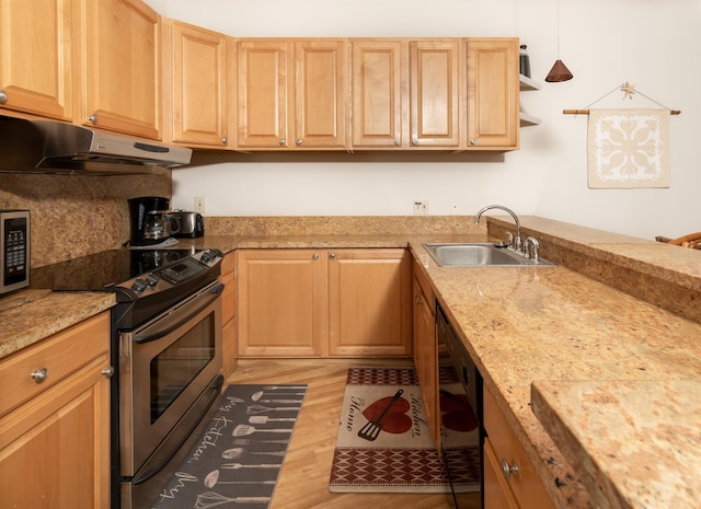 kitchen featuring sink, decorative light fixtures, light wood-type flooring, light brown cabinetry, and appliances with stainless steel finishes