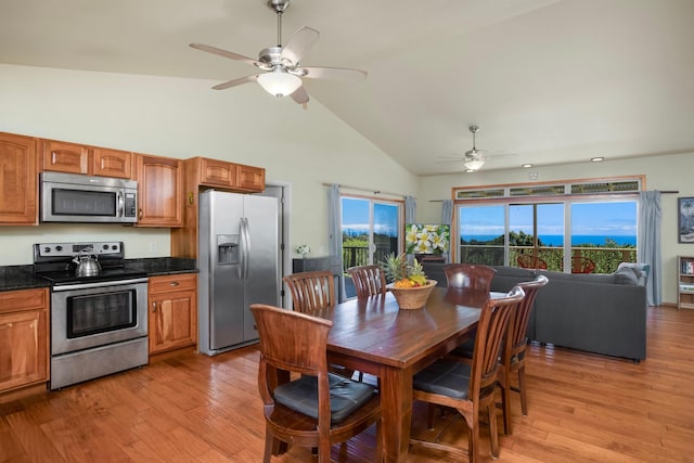 698 Kaupakalua Rd Unit A, Haiku, HI 96708 - kitchen featuring appliances with stainless steel finishes, ceiling fan, high vaulted ceiling, light wood-style flooring, and brown cabinets