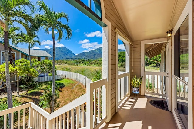 balcony featuring a mountain view and a porch