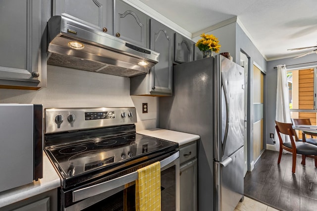 kitchen with gray cabinets, ornamental molding, light hardwood / wood-style flooring, and stainless steel appliances