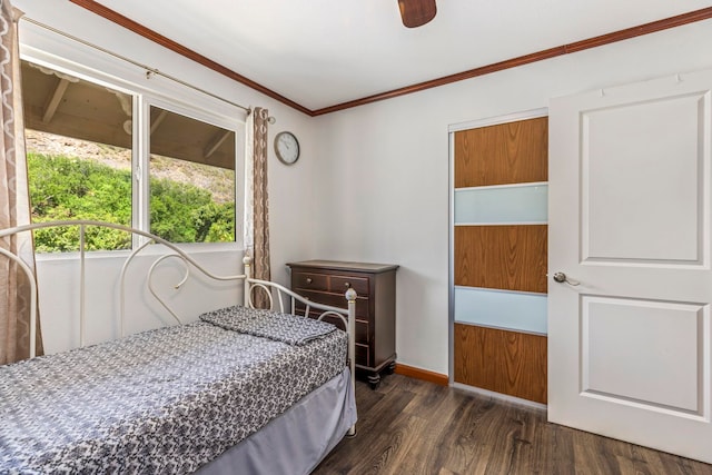 bedroom with ceiling fan, crown molding, and dark hardwood / wood-style flooring