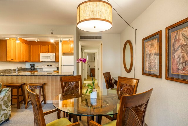 dining space featuring light colored carpet