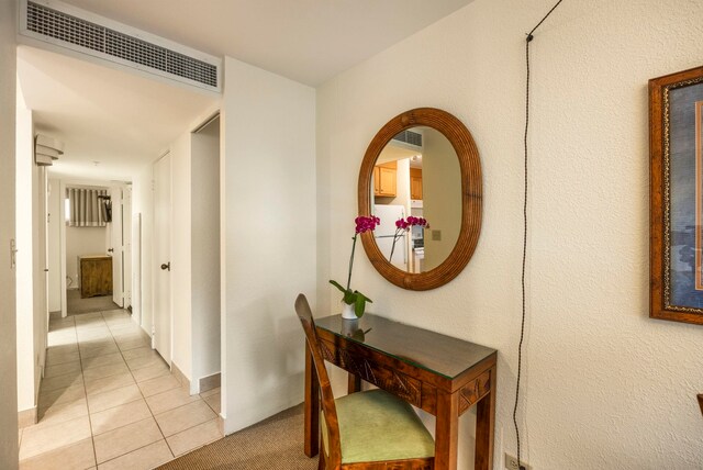 hall featuring light tile patterned flooring