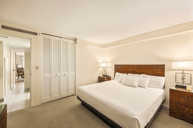 carpeted bedroom with a closet