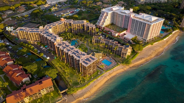 birds eye view of property featuring a beach view and a water view