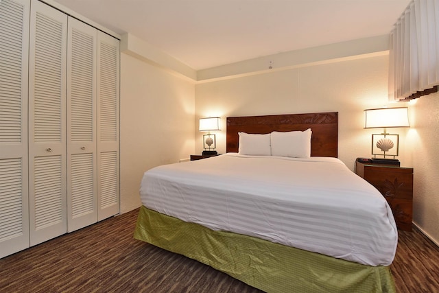 bedroom featuring dark hardwood / wood-style flooring and a closet