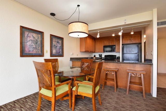 dining room with sink and rail lighting