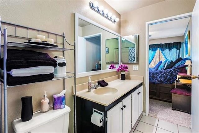 bathroom with vanity, tile patterned floors, and toilet