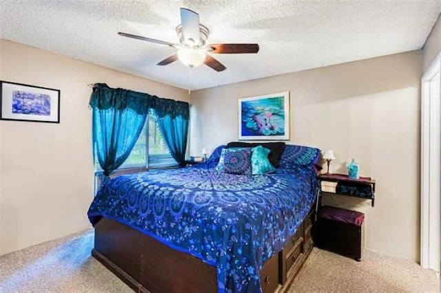 bedroom with carpet, a textured ceiling, and ceiling fan